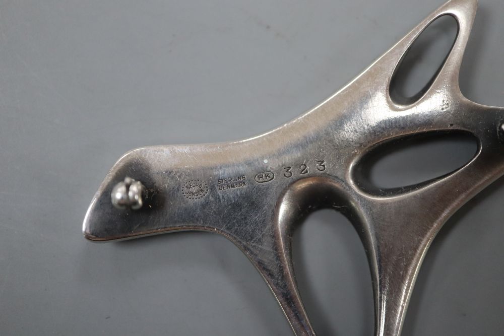 A post 1945 Henning Koppel for Georg Jensen sterling and black enamel modernist brooch, design no. 323, 58mm, gross 29 grams.